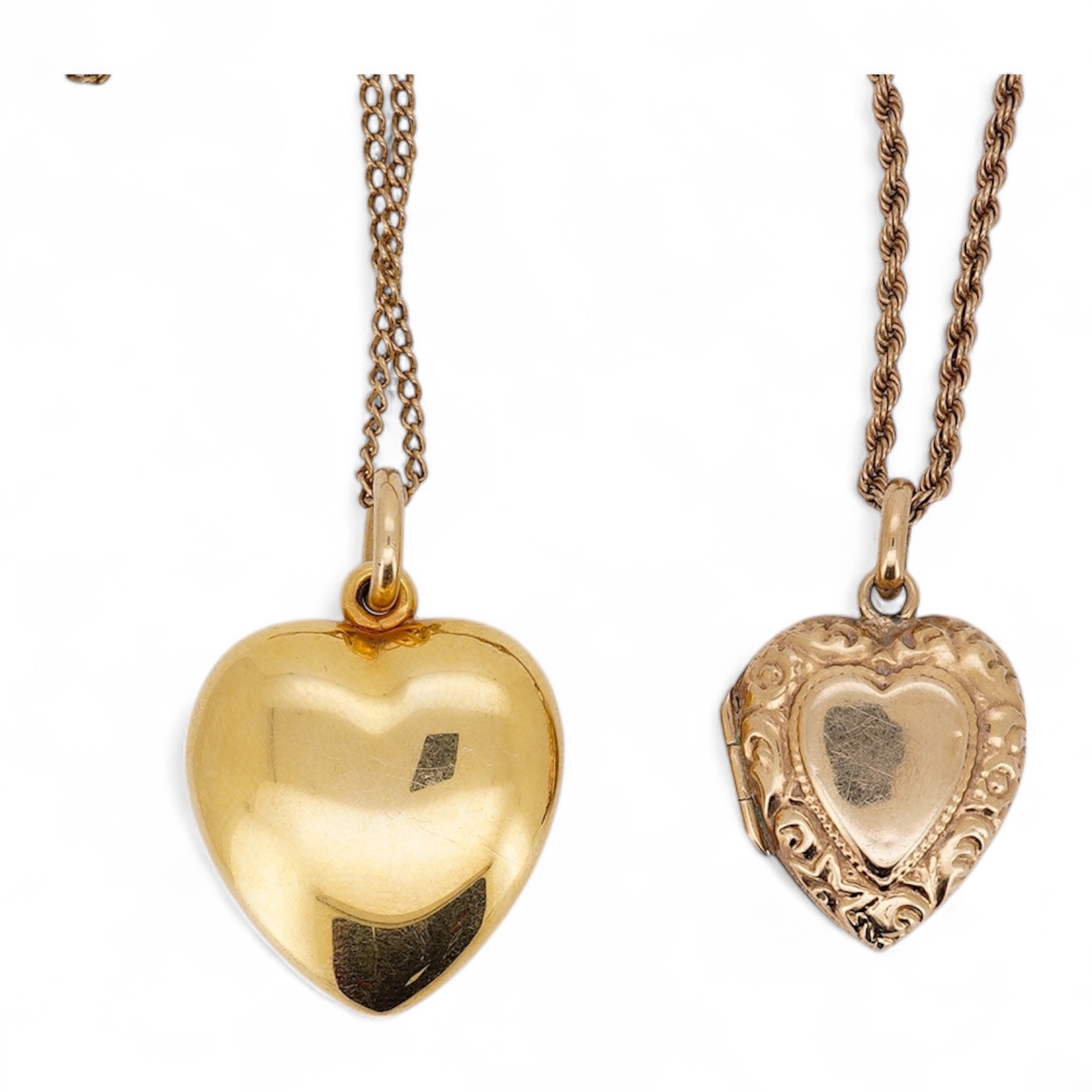 A modern embossed 9ct gold heart shaped locket, 21mm, on a similar 9ct gold rope twist chain, 46cm, together with one other yellow metal heart shaped locket, on a yellow metal chain, gross weight 14.5 grams. Condition -